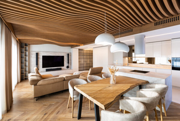 Open-plan living room and kitchen of a luxury apartment beneath the Airwood flowing wooden lamella ceiling