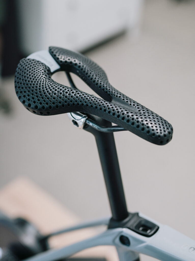Black 3D-printed Posedla Joyseat saddle mounted on a bike seatpost, top view of the honeycomb lattice